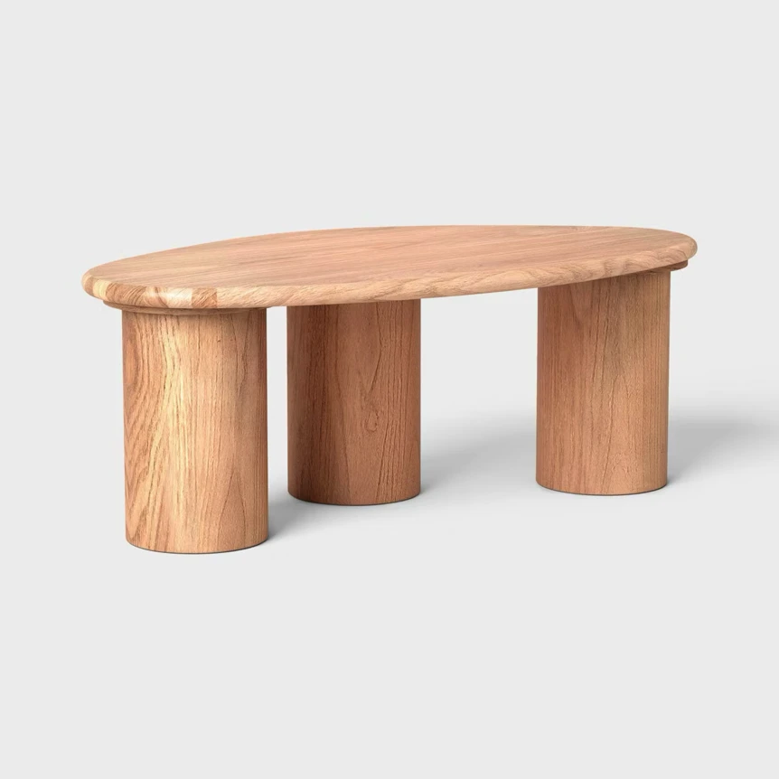 Organic curved coffee table with natural wood finish and three cylindrical legs on neutral background