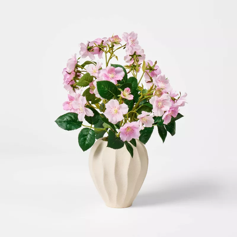 Pink faux roses in cream ribbed vase from Target against white background