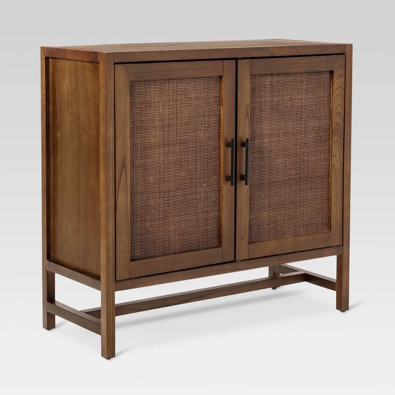 Wooden sideboard cabinet with woven rattan door panels and mid-century modern design on white background