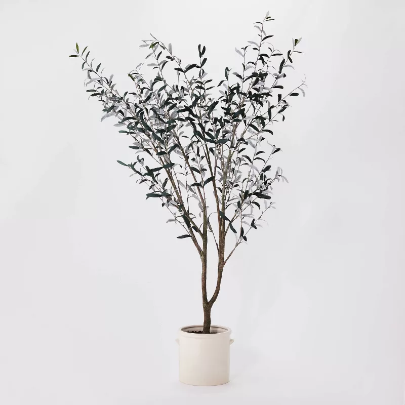 Faux eucalyptus tree in cream pot with realistic gray-green leaves and natural brown branches from Target