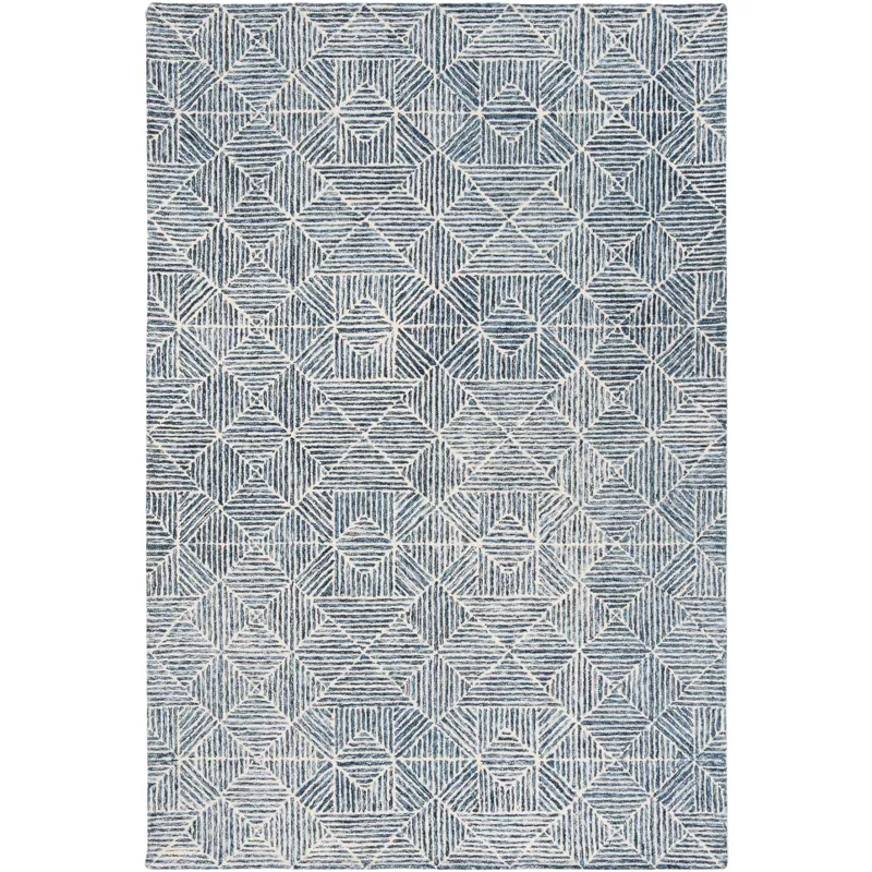 Abstract geometric patterned hand tufted area rug in gray and white tones with textured diamond motifs