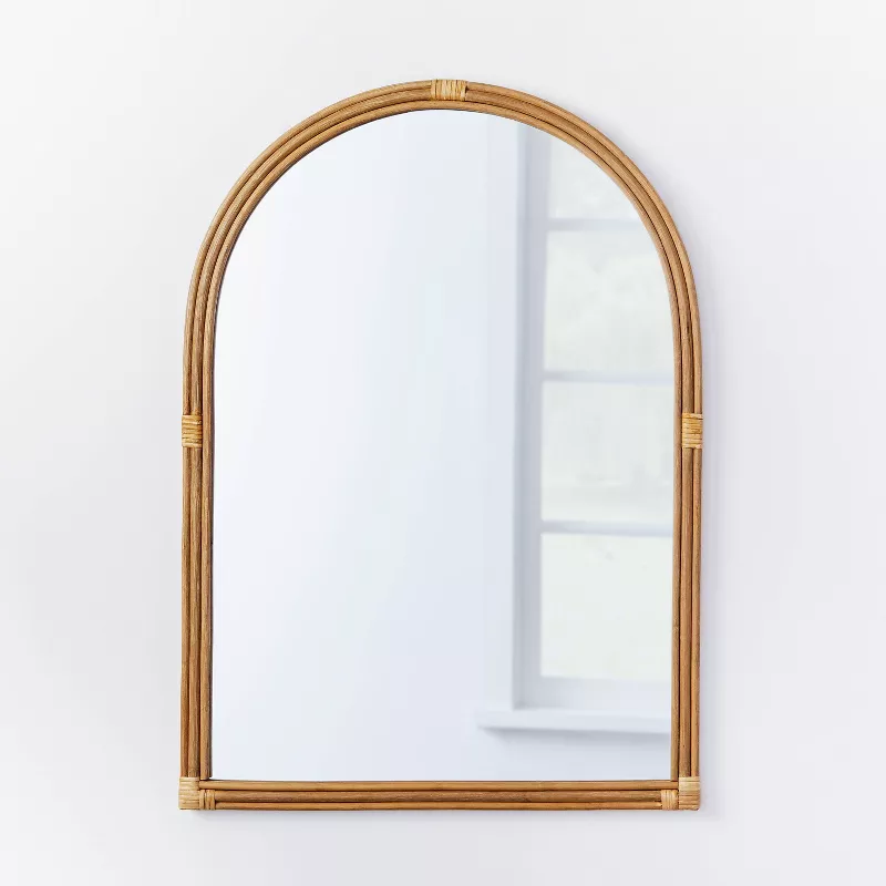 24 x 34 inch rattan arched wall mirror with natural bamboo frame on white wall
