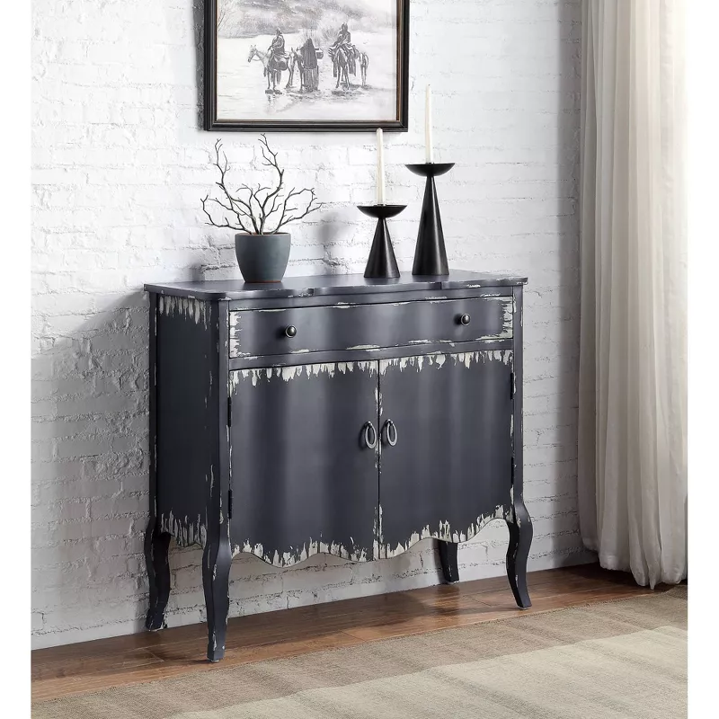 Distressed dark gray console table with ornate legs and decorative vases in modern entryway setting