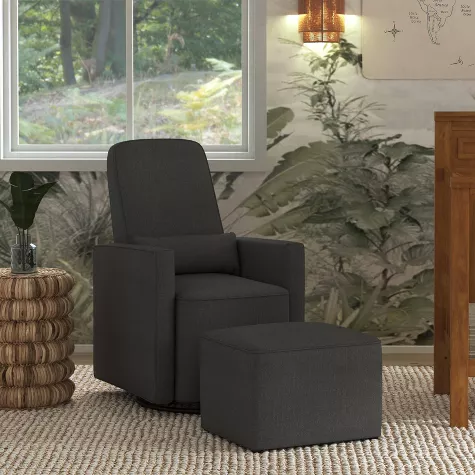 Modern dark gray glider recliner chair with matching ottoman in bright nursery room with plants and windows