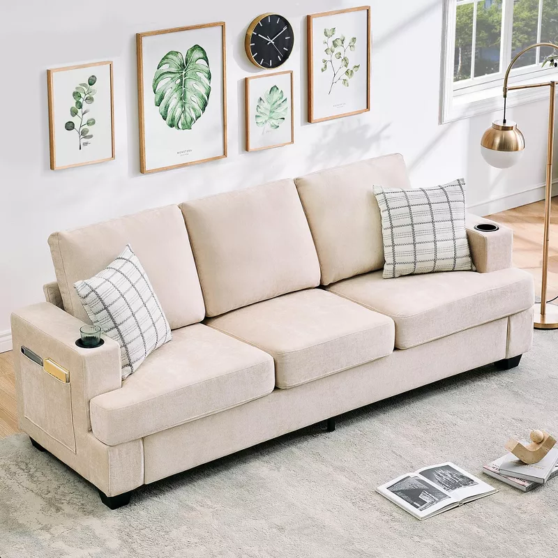 Beige fabric sofa with checkered pillows in modern living room with botanical wall art and side table