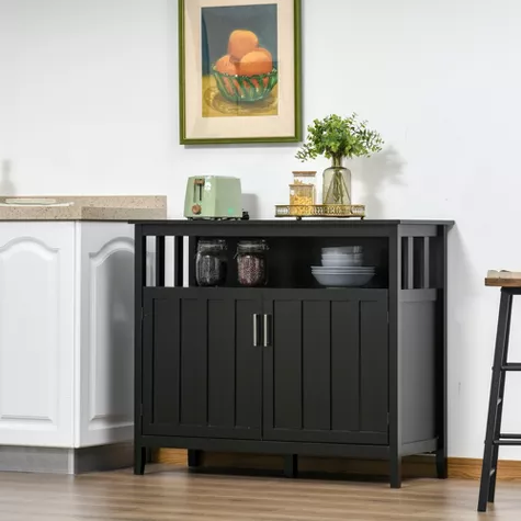 Black wooden sideboard with open shelving and cabinet doors in modern dining room with framed art and decor