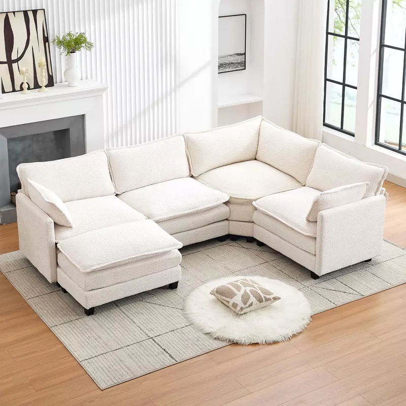 White sectional sofa with chaise lounge in bright modern living room with hardwood floors and area rug