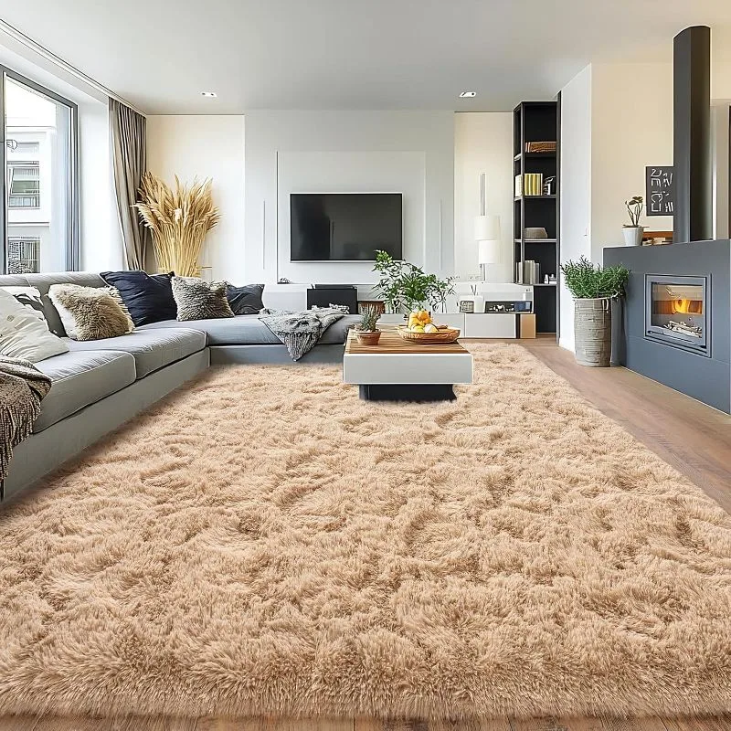 Large beige shag rug in modern living room with gray sofa and fireplace creating cozy atmosphere