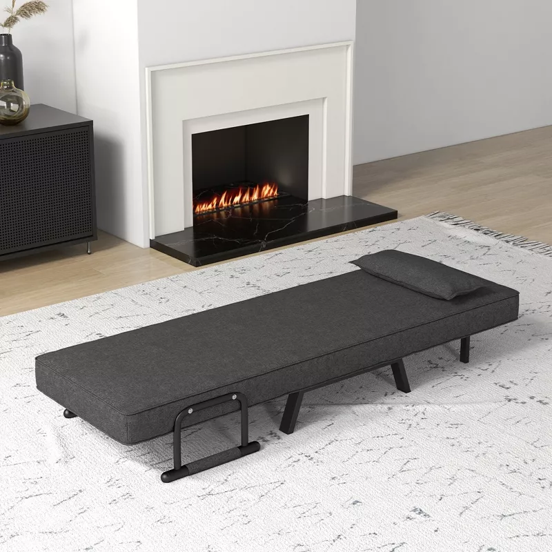 Convertible sleeper ottoman in charcoal gray that unfolds into guest bed, shown in modern living room with fireplace