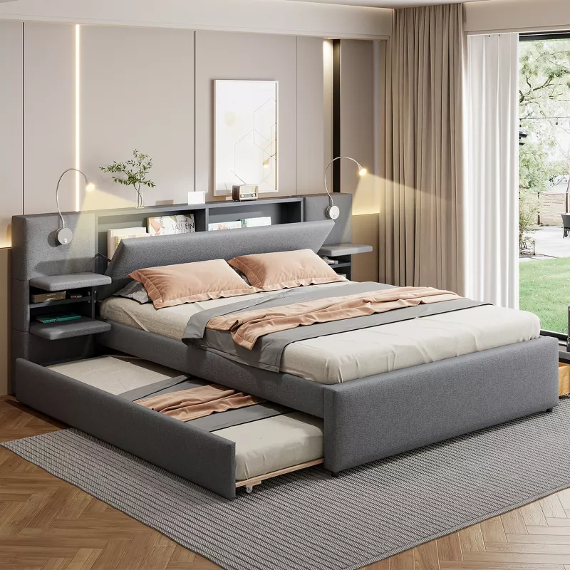 Modern gray upholstered platform bed with built-in storage drawers, shelving headboard, and pull-out trundle in bedroom