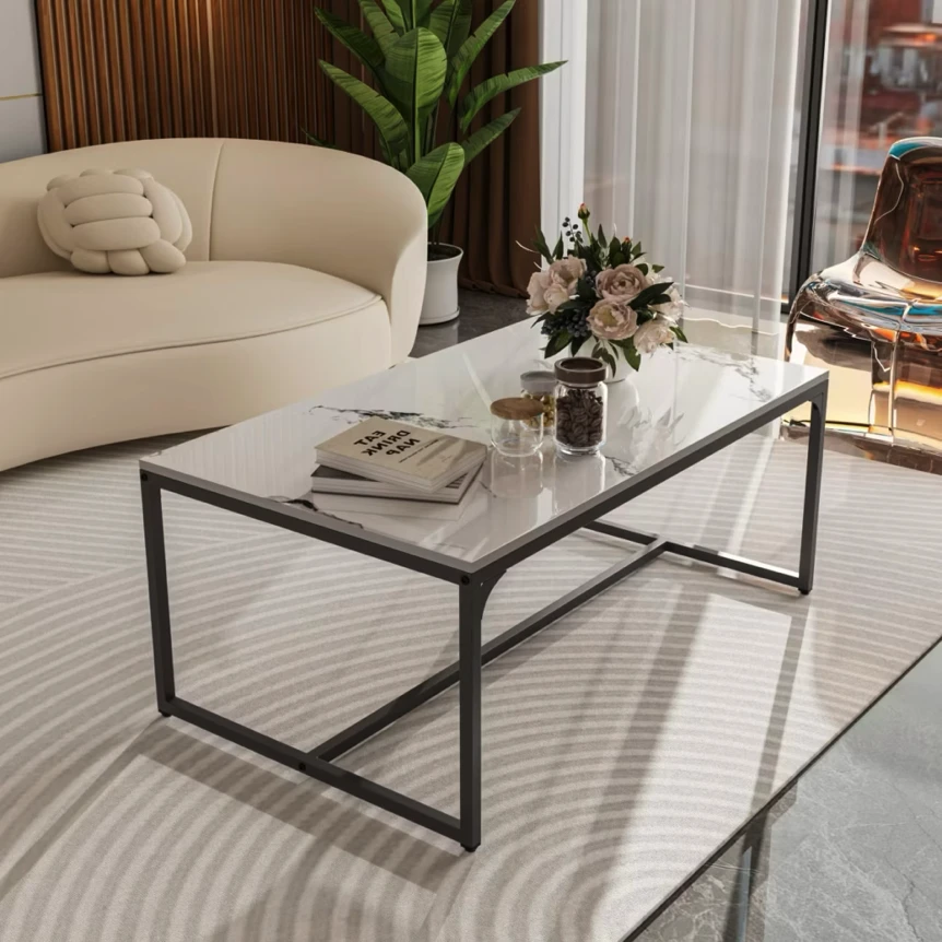 Modern marble coffee table with black metal frame in minimalist living room with beige sofa and area rug