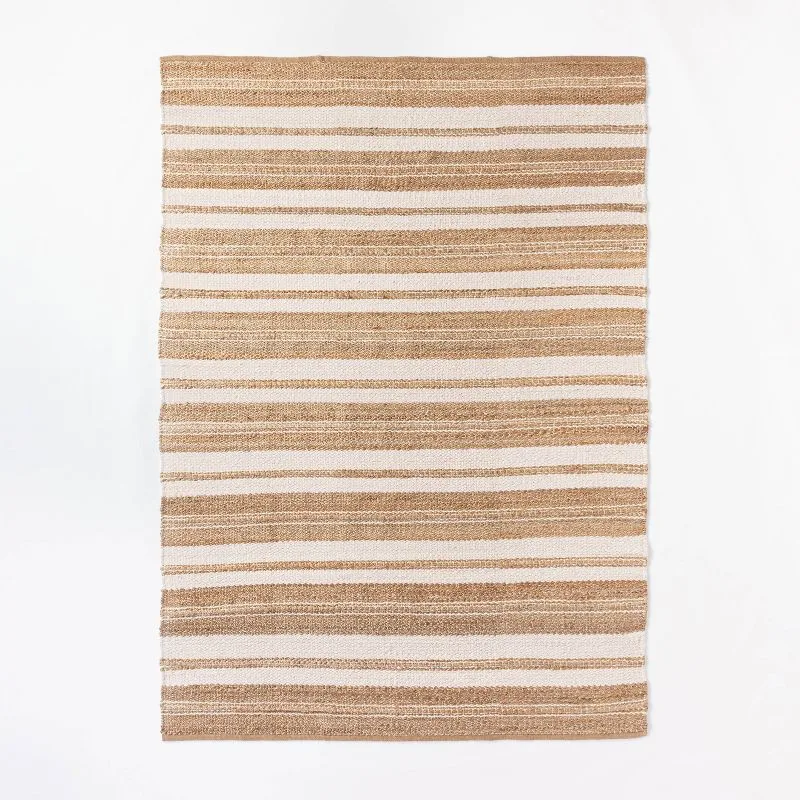 Striped jute and wool area rug in tan and cream horizontal stripes on white background