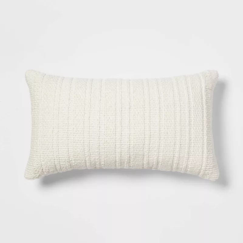 Oversized cream lumbar pillow with textured woven stripe pattern on white background