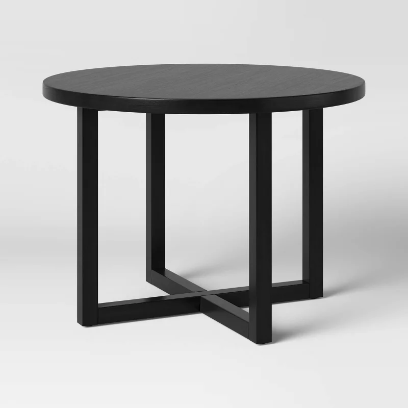 Round black dining table with X-base pedestal legs from Target's furniture collection