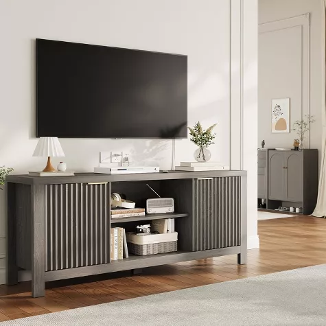 Modern gray sideboard with fluted doors beneath wall-mounted TV in contemporary living room with white subway tile backsplash
