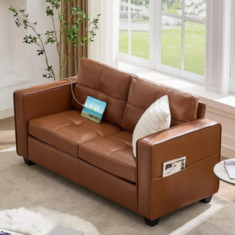 Brown leather sofa with storage pockets and pillows in bright living room near large window