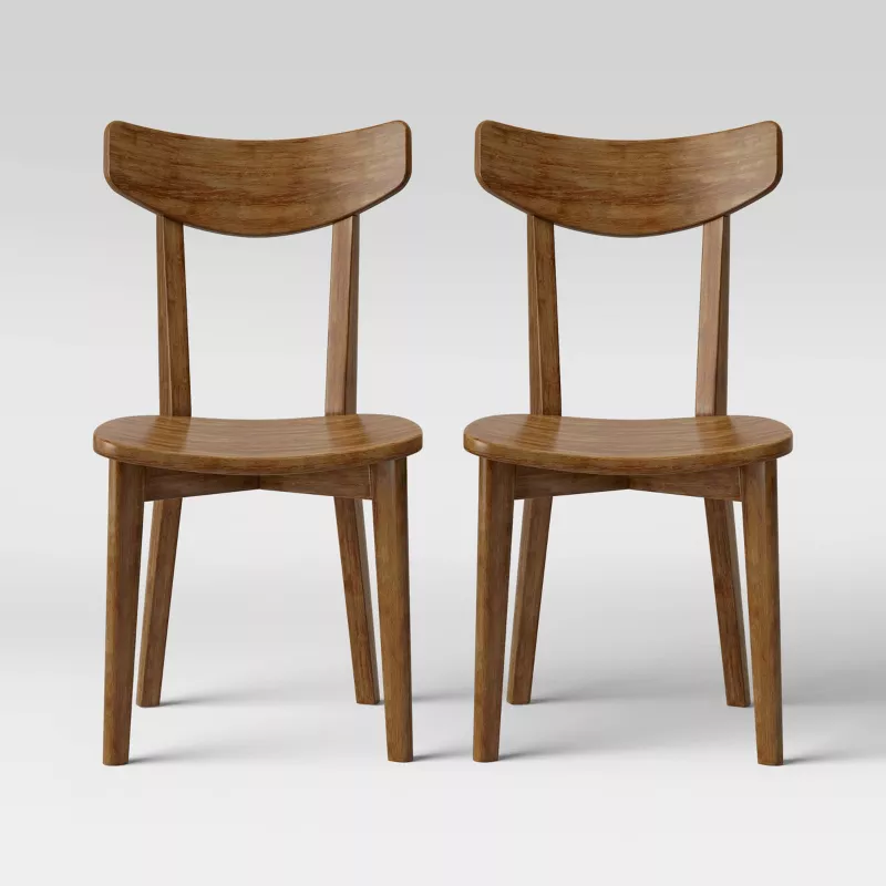 Two mid-century modern wooden dining chairs with curved backs and round seats in natural walnut finish