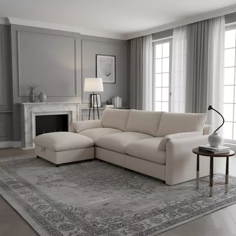 Beige sectional sofa with chaise in elegant gray living room with fireplace and large windows