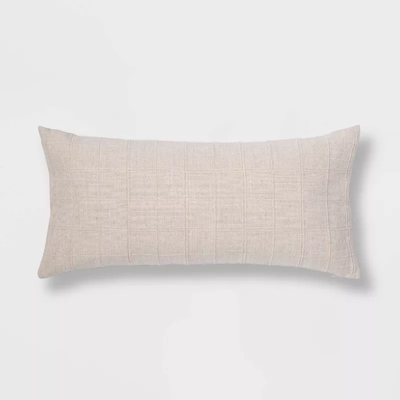 Oversized cream woven washed windowpane lumbar throw pillow with textured fabric on white background