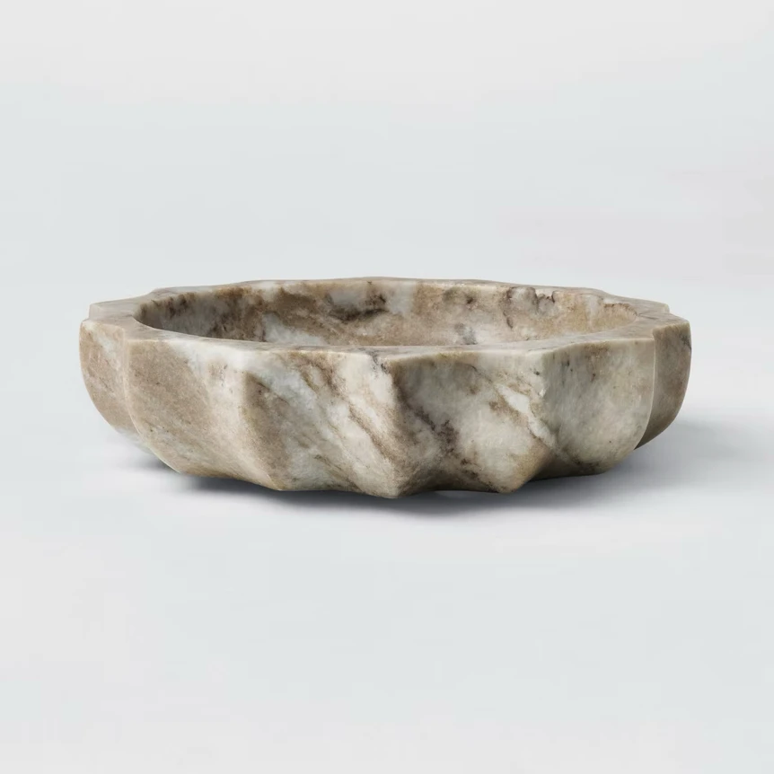 Natural stone carved bowl with organic shape and neutral gray tones for timeless home decor