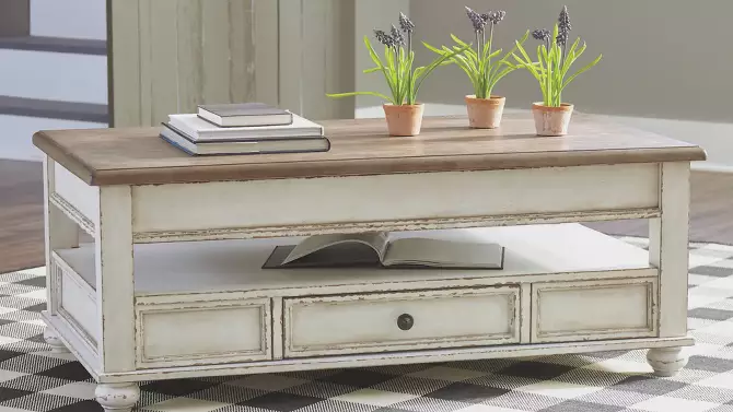 Realyn two-tone coffee table with lift top in white and brown finish with decorative storage drawers