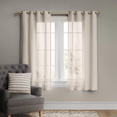 Light filtering cream textured weave grommet curtain panel hanging on window with gray couch and striped pillow