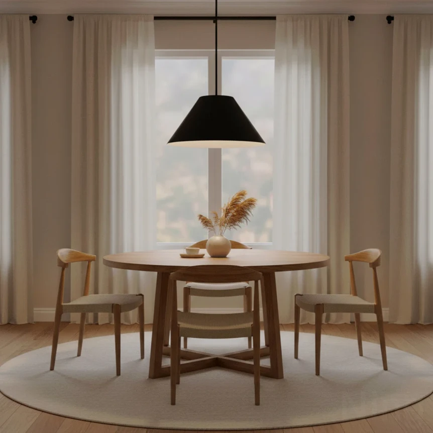 Modern dining room with black pendant light over round wooden table and four chairs with sheer curtains