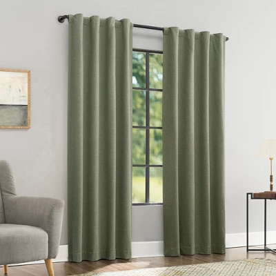 Sun Zero Treviso moss green blackout curtain panels with magnetic closure hanging on window in modern living room
