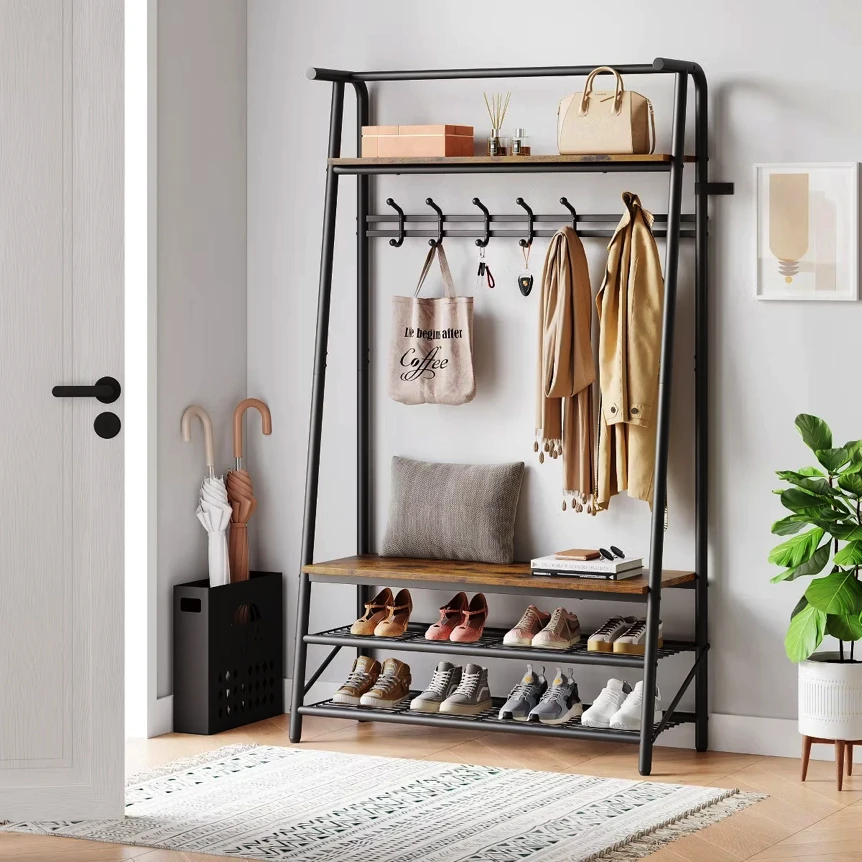 Black metal hall tree with coat hooks, upper shelf, bench seat, and shoe storage displaying jackets, bags, and footwear