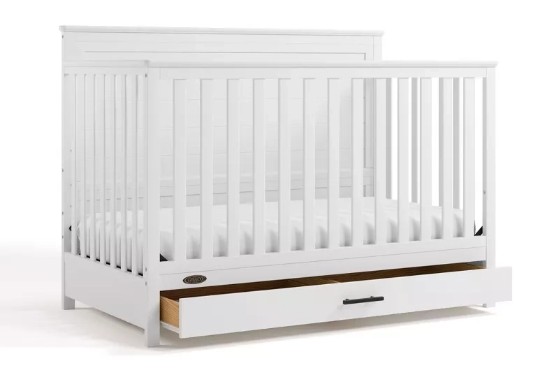White convertible crib with storage drawer underneath for nursery bedroom furniture