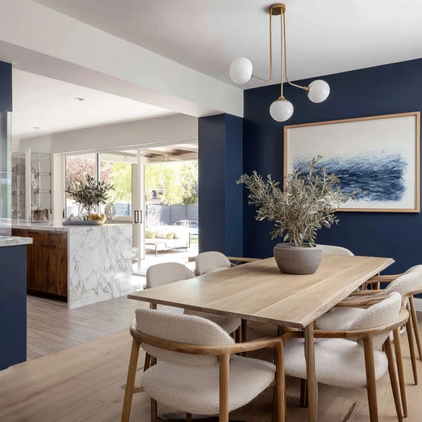 Navy Lacquer Accent Wall Framing a Light Wood Dining Table