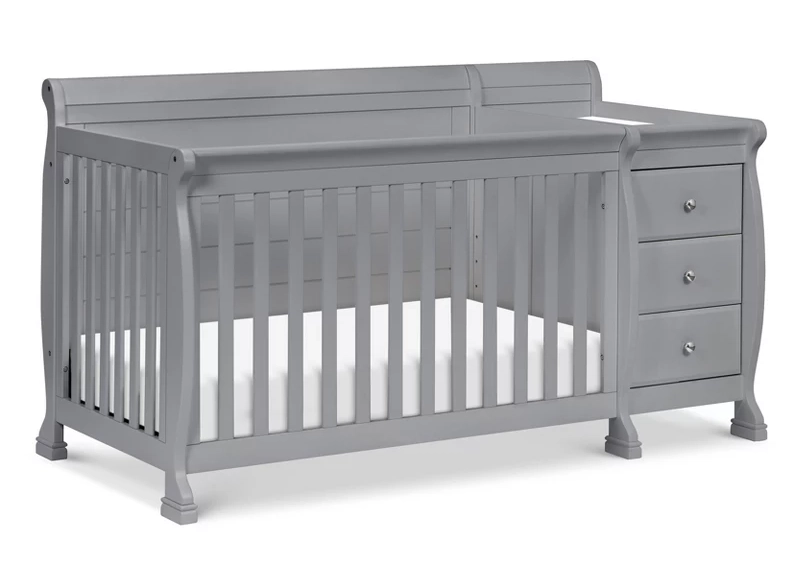 Gray convertible crib with attached changing table and dresser for nursery furniture setup