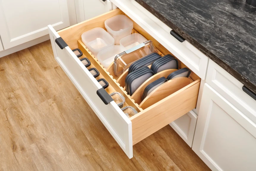 open kitchen drawer with organized pots and lids in a deep drawer with dividers)