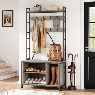 Hall tree with bench featuring coat hooks, upper shelf, shoe storage cubbies, and umbrella stand in entryway