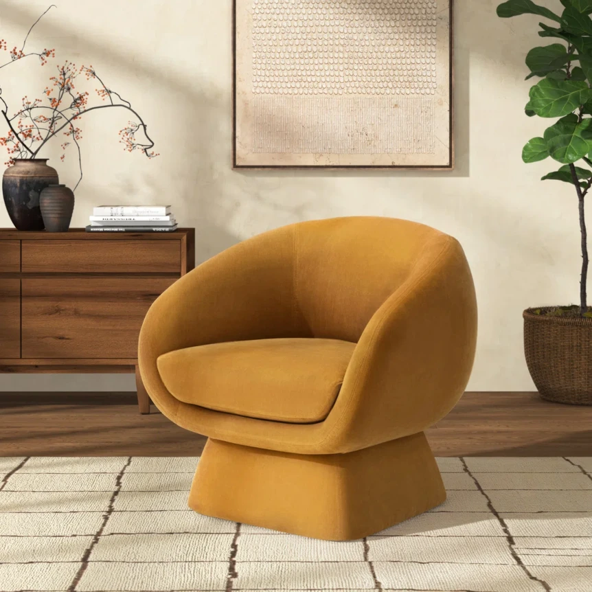 Modern mustard yellow swivel accent chair in contemporary living room with wooden dresser and natural decor