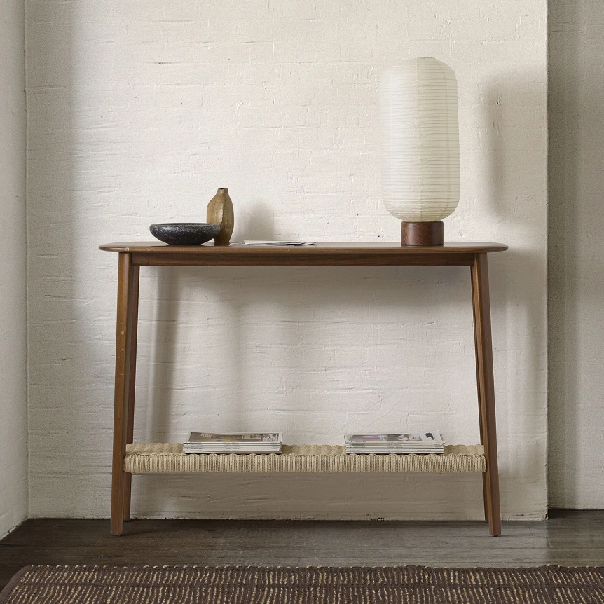 Modern wooden console table with minimalist decor and lower shelf storage in neutral living room setting
