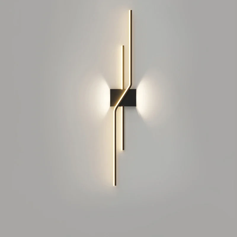 Modern wall sconce with geometric bronze finish and vertical LED light strips creating ambient glow on gray wall