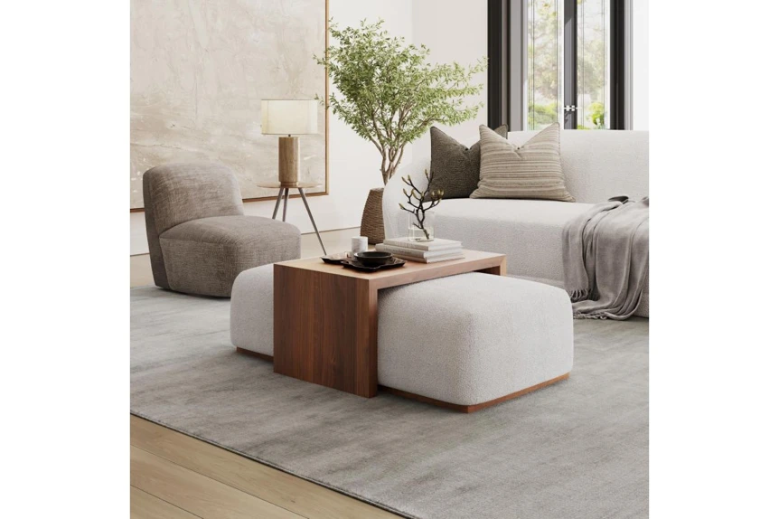 Modern living room with wooden side table, beige pouf ottoman, and minimalist furniture arrangement