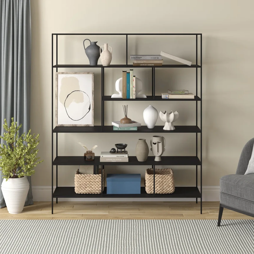 Modern black metal bookshelf with decorative items and storage baskets in contemporary living room setting