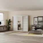 Modern bedroom with light wood flooring, minimalist furniture, natural lighting, and neutral color palette