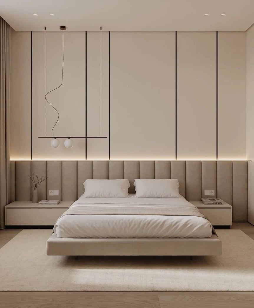 Modern minimalist bedroom with beige tones, platform bed, ambient lighting, and marble accent wall panels