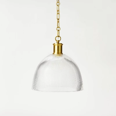 Reeded glass dome pendant light with brass chain and hardware on white background