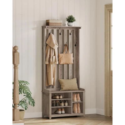 VASAGLE hall tree with bench, coat hooks, and shoe storage shelves in rustic gray finish against white paneled wall