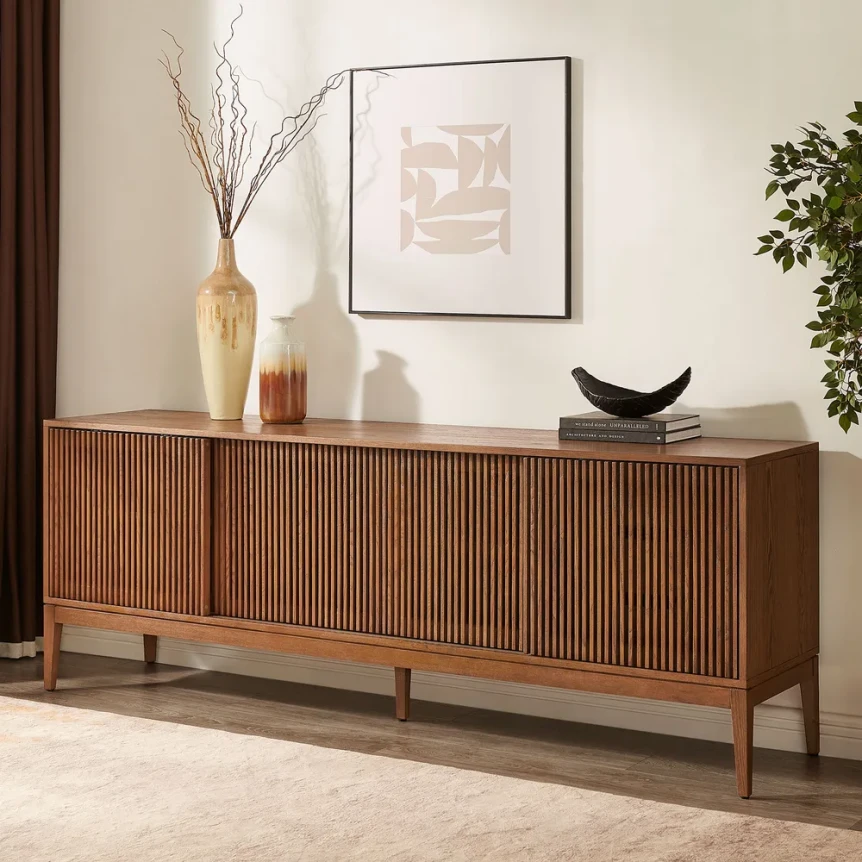 Mid-century modern credenza with fluted wood doors, tapered legs, and minimalist decor styling