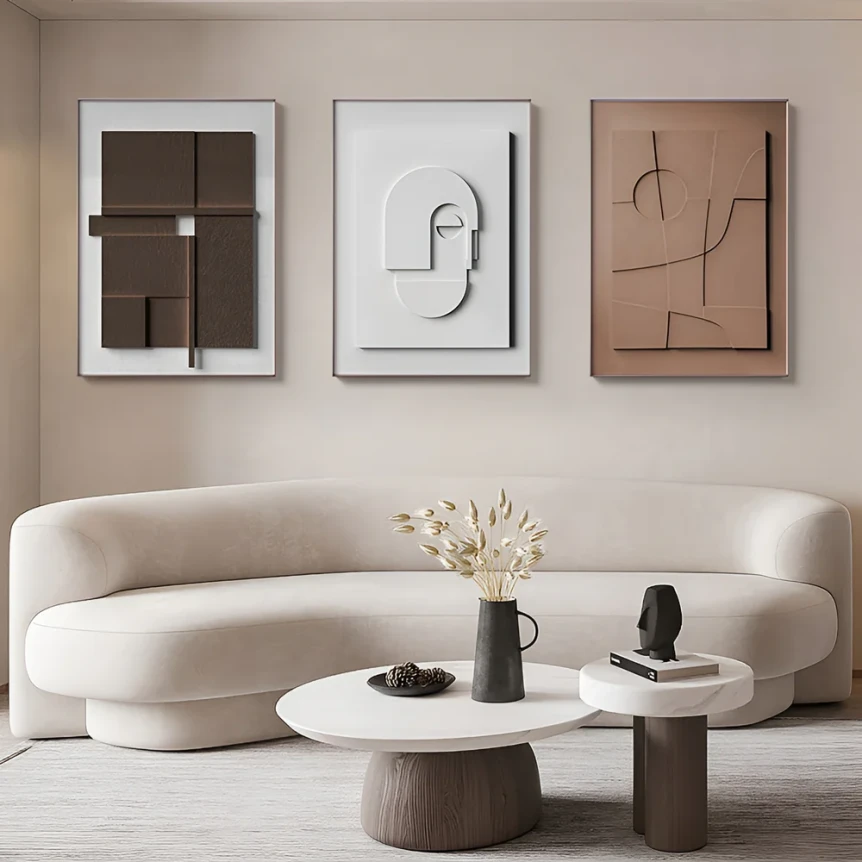 Minimalist Japandi living room with curved beige sofa, abstract wall art, and neutral coffee table decor