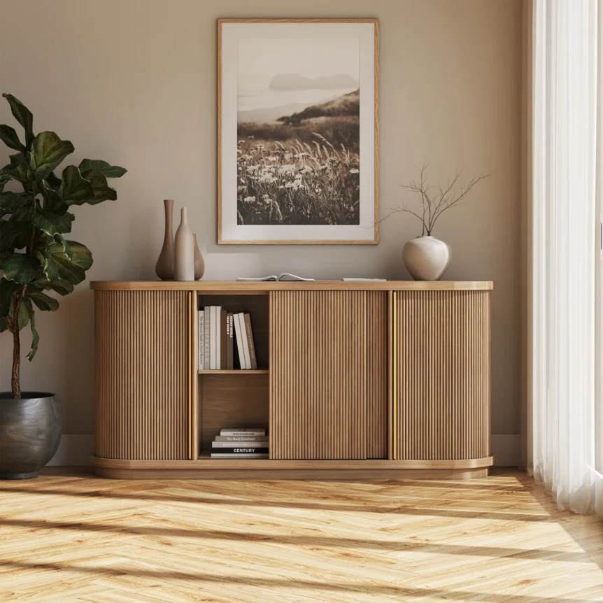 Modern wooden entryway console table with sliding doors and open shelving displaying books beneath framed landscape art