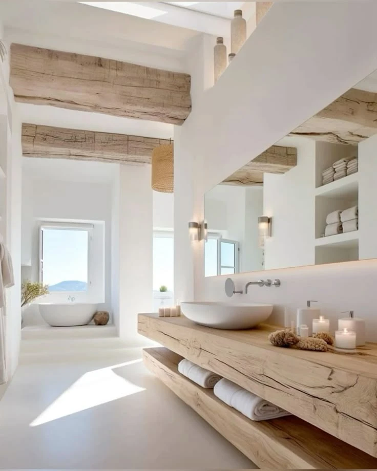 Minimalist bathroom with natural wood beams, white walls, vessel sink, and cozy hygge-inspired Scandinavian design
