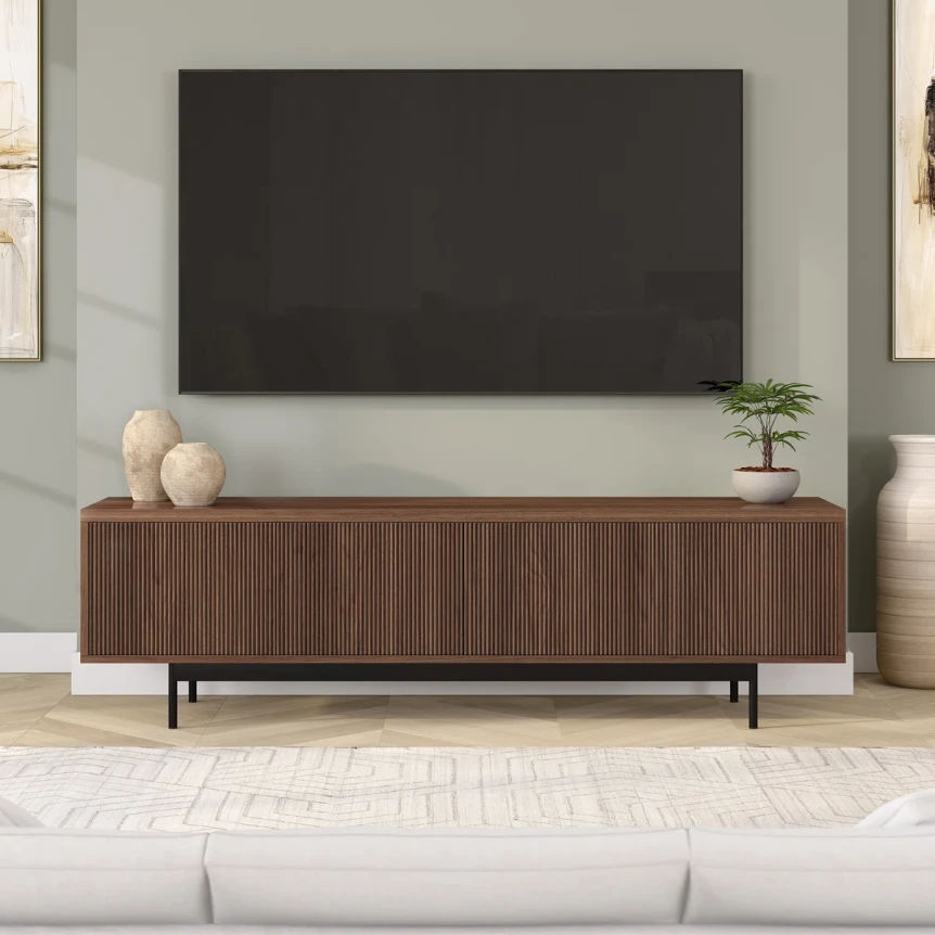 Modern walnut TV stand with black legs beneath wall-mounted flat screen in contemporary living room