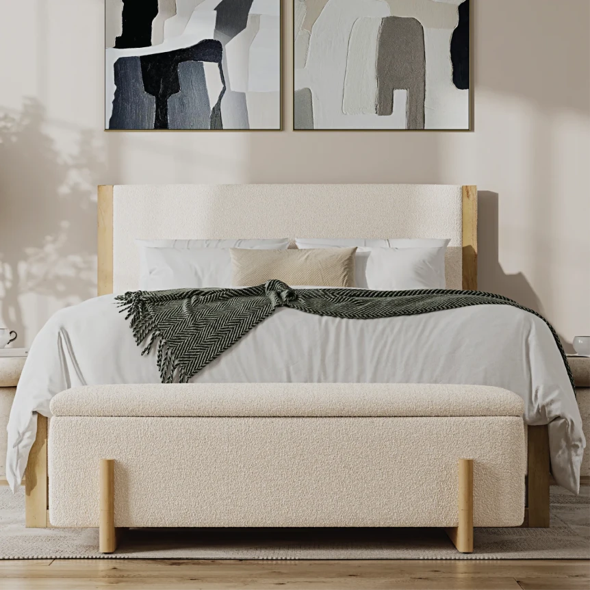 Modern upholstered bed with cream fabric and wood accents, styled with neutral bedding and storage bench at foot