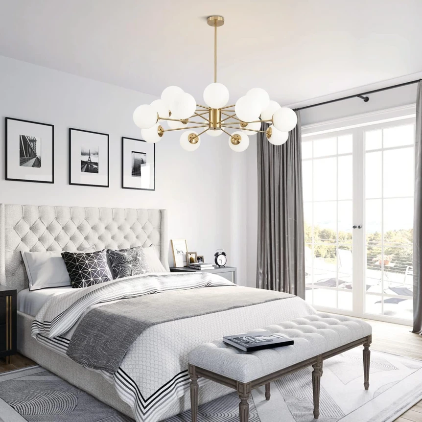 Mid-century modern bedroom with tufted headboard, brass chandelier, and gray accents in elegant white space